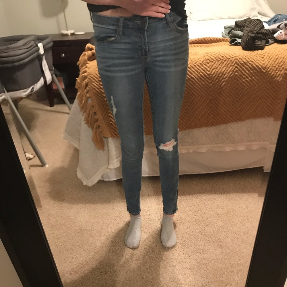 Versace distressed skinny jeans with ankle zip.